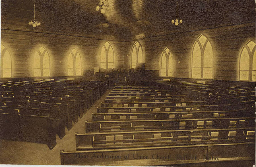 A postcard showing the main auditorium of the Union Church in Potlatch, Idaho. The building was constructed in 1912 by the Potlatch company and was used as both a church (representing as many as 22 different Protestant denominations) and community center. The auditorium pictured here seated 700. The average Sunday school attendance was 225. The structure burned down in 1951.