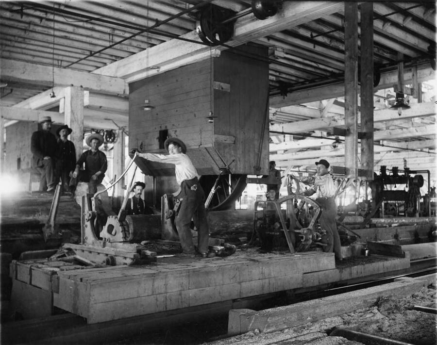 Men pose for a picture inside the mill at Potlatch.