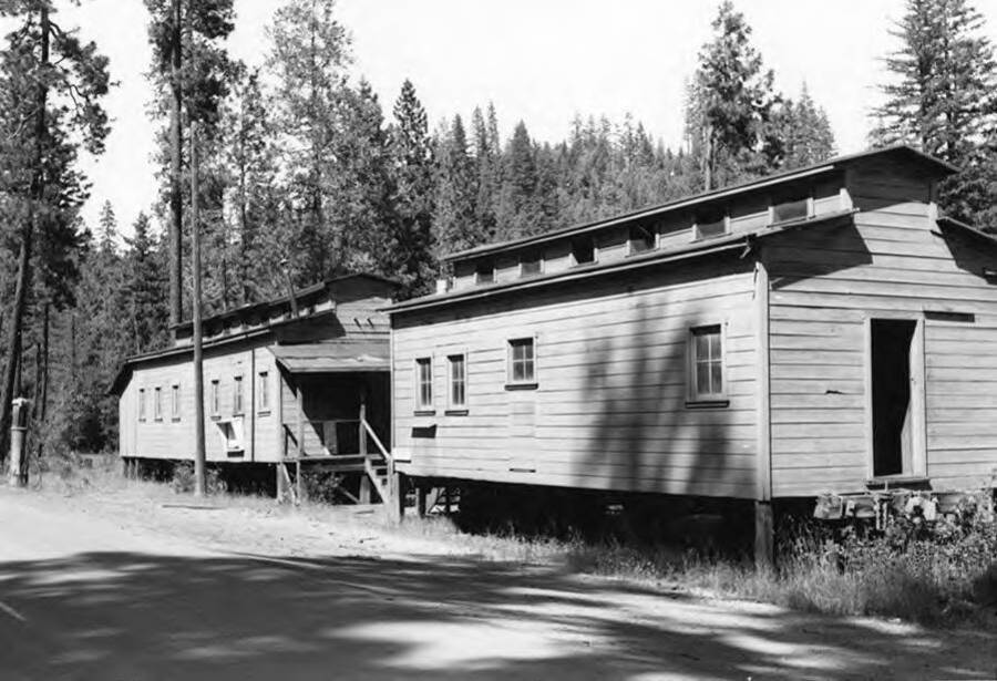 Camp cars similar to the ones used in many of the camps in Idaho. These sit at Camp 4 in Butte Falls Oregon. Stamped on the back of photograph: 'John R. Cummings 620 Ash Street, Walla Walla, Washington.'