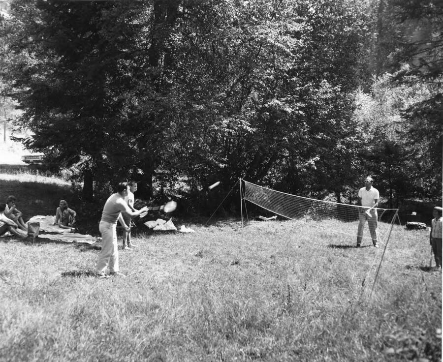 A group of people play badminton at the Sweetwater Creek Picnic area.