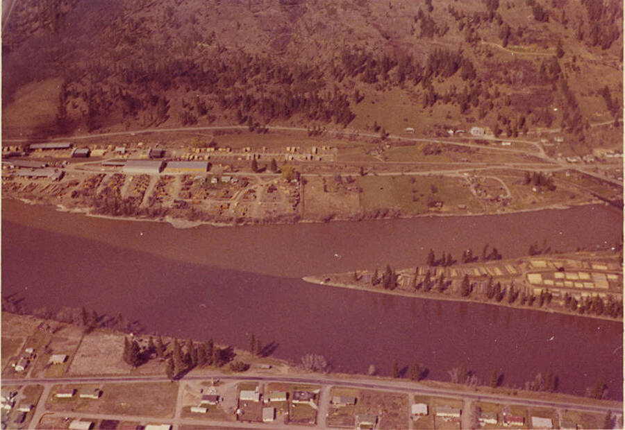 The water of the Orofino Creek has changed with the run-off of bedloads of silt. Description taken from envelope.