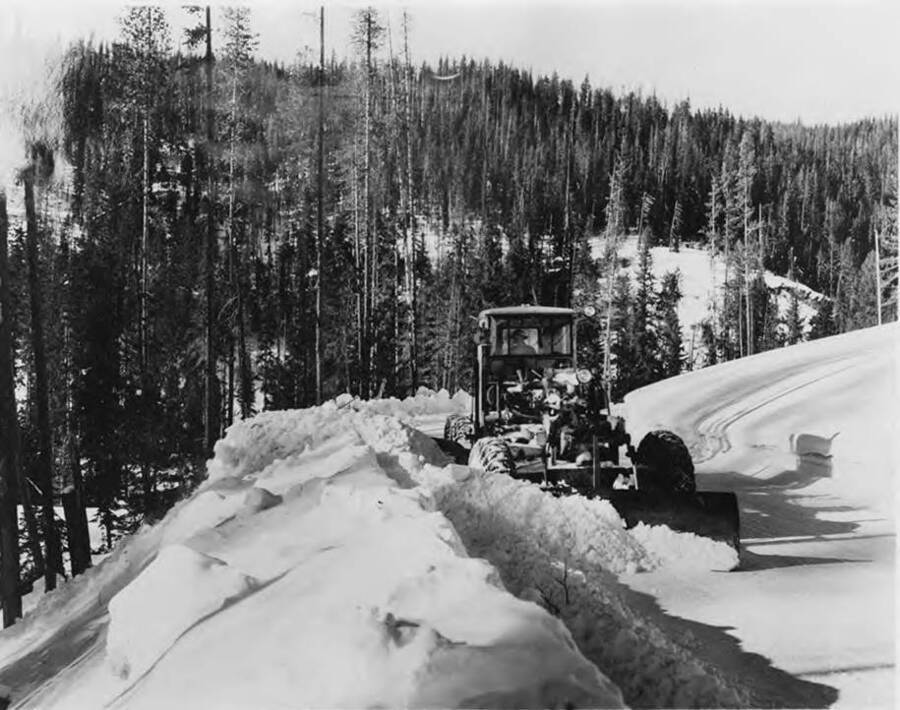 A tractor is used to plow away snow near Avery, Idaho.