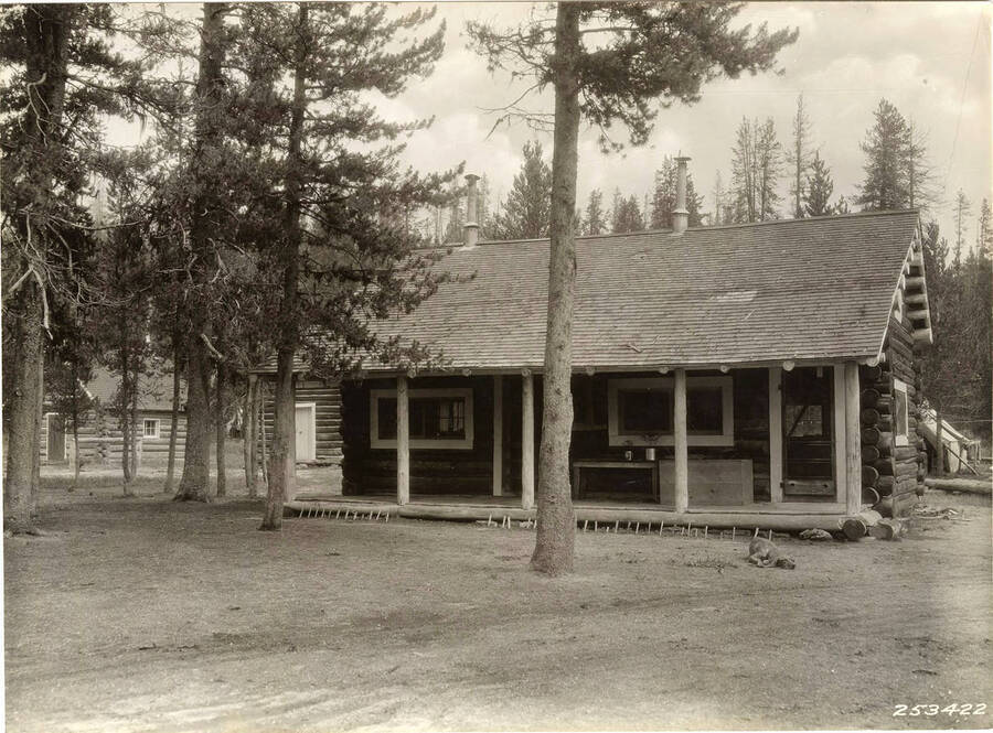 One of the cabins on the Elk Creek R.S. In front of the cabin lies a dog.