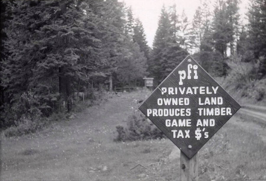 A sign, which reads "privately owned land produces timber game and tax $'s)" at the entrance to part of PFI lands.