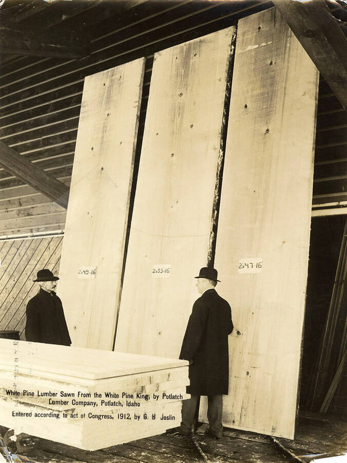 A.W. Laird and Mark Seymour stand next to 'white pine lumber sawn from the White Pine King' in Potlatch, Idaho.
