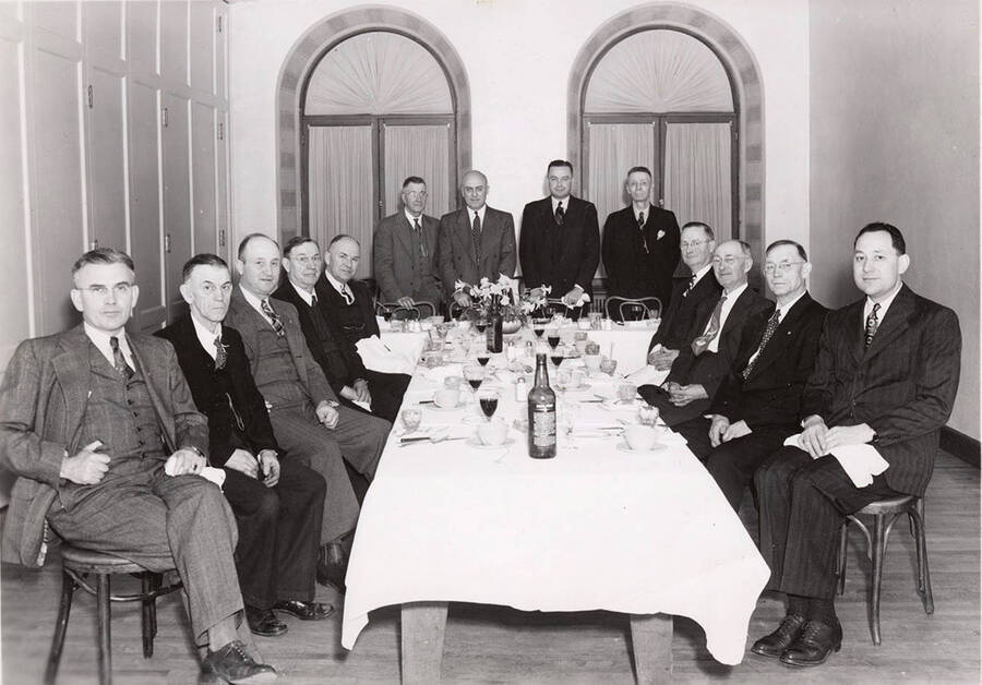 The description on the back reads 'banquet at Lewis Clark Hotel for Clearwater employees retired March 31, 1947.' It then lists the employees: C. J. Cummerford, C. J. Carter, S. E. Andrew, Jim Bartholow, O. H. Leuschel, M. L. Sund, H. L. Torsen, D. S. Troy, Fred Frost, Roy Huffman, Jacob Gonser, Ed Olsen, and John Aram.