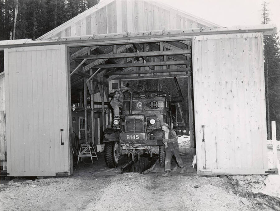 Truck is undergoing daily check. Actual check required three minutes, not including adding of oil. Description taken from the back of the photograph which was printed in The Timberman journal.