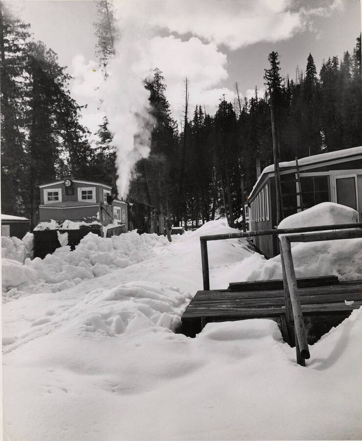 The description on the back of the photograph reads 'plowing out rail line to camp 35, one of camps that used by Potlatch mill.'