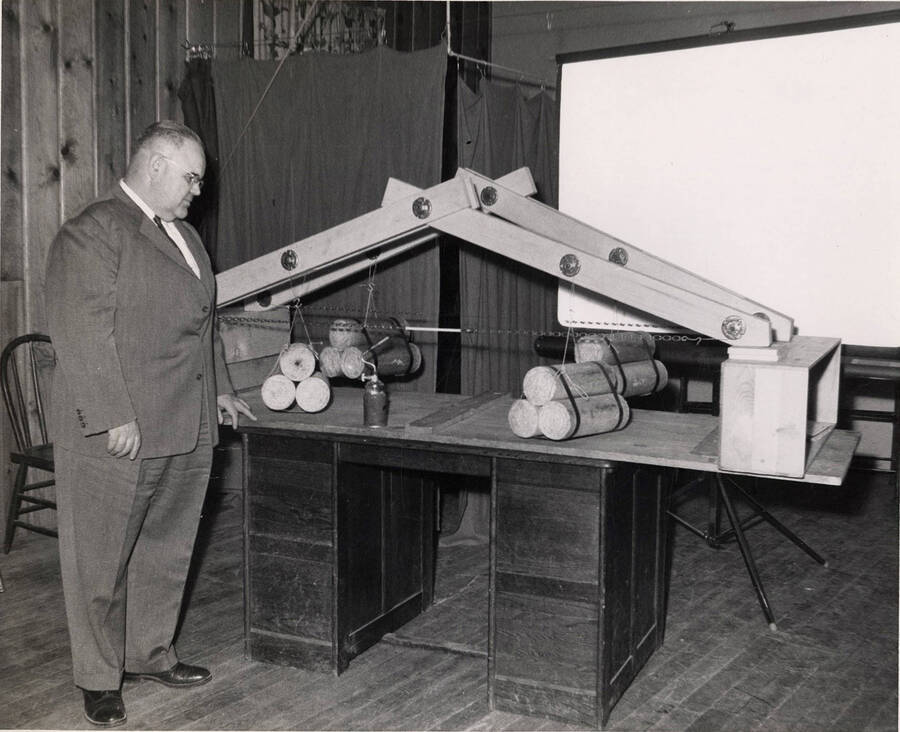 A man studies a Presto Log demonstration.