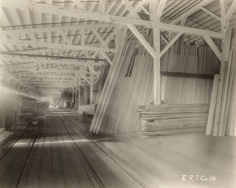 Lumber is stored at the Rutledge Mill. In the lower left of the photograph, the tracks for transporting the lumber can be seen.