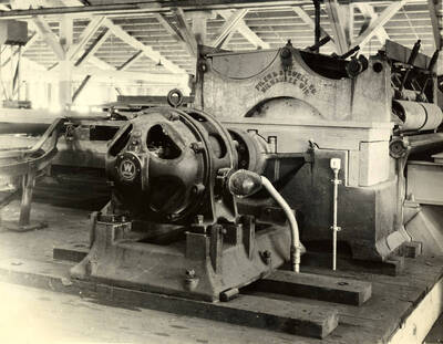 A piece of mill machinery. Stamped on the machinery, the words read 'Filer and Stowell Co. Machinery.'