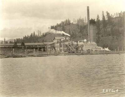 Looking from Coeur d'Alene Lake at Rutledge Mill. Written on the back of the photograph is "Edward Rutledge Timber Co. - Coeur d'Alene, Idaho."