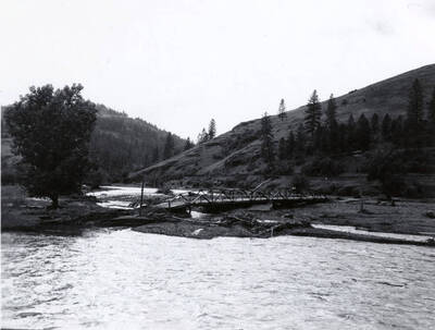 A bridge lies on the ground after being washed out from flood waters.