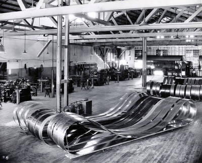 Band saws for the Clearwater sawmill. The description on the back of the photograph says: "new 14" wide - we wear down and sharpen until 9" wide. 52 feet in cir. - travel at 10,000 rpm - cast $1,000.00 new."