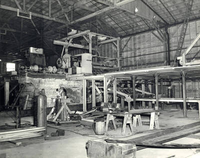 Photograph shows part the sawmill process.