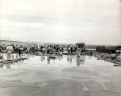 Men working to construct the roof using cement at the Clearwater paper mill.