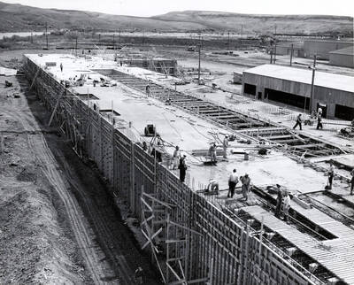 Looking at one side of the building of the Clearwater paper mill plant while the men work on the roof.
