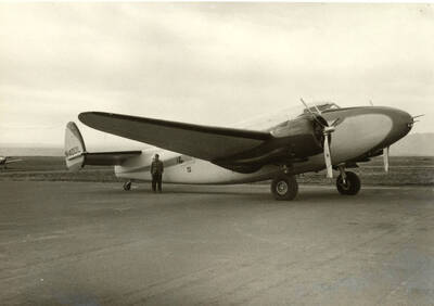 A man stands in front of a Leanster Mark 2 with a tail number of N400L airplane at the Lewiston Airport.