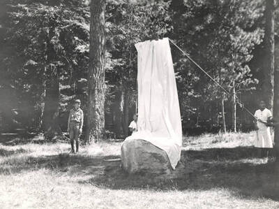 Two of A.W. Laird's grandchildren, Mary Ann and Allison Laird Decker prepare to unveil the monument.