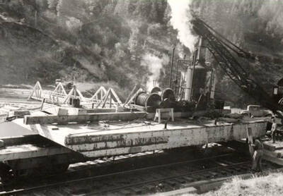 The Potlatch Navy, a multipurpose craft used as an icebreaker, pile driver, skyline rig and sea-going donkey engine on the pond on a railway flatcar.