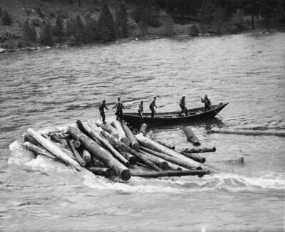 Men work to clear a log game on Bedrock creek, Idaho.
