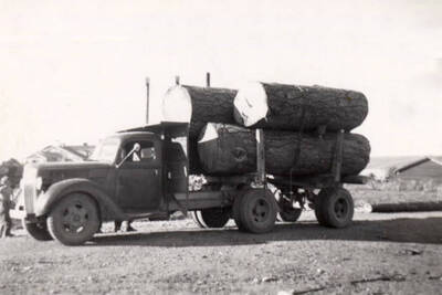 Logs loaded on a truck and transported to the pond.