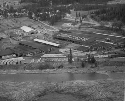 The mill on Lake Coeur D'Alene. At the bottom of the photograph, there are logs waiting to go into the mill to be processed.