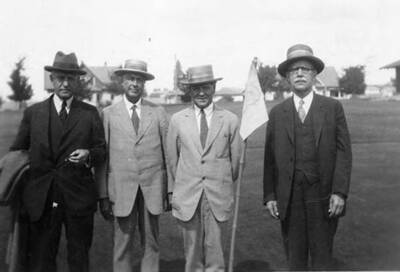 Mr. John Weyerhaeuser, Jack Grwin, and A.W.L (Andrew W. Laird) and a fourth man pose for a picture in Potlatch, Idaho.