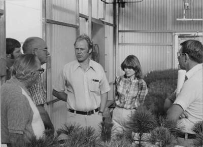 A men shows off the Lewiston Nursery and Greenhouse and the seedlings of different trees that they have waiting to be planted.