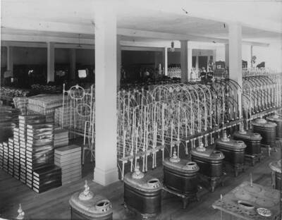 The home furnishings section of the store in Potlatch, Idaho. In the photograph are bed frames, mattresses, and stoves.