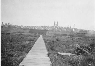 Looking towards the train station and residence hill in Potlatch, Idaho. In the center of the picture is a long wooden sidewalk.