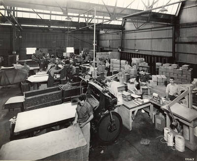 Men and women work to process different types of paper products at the mill in Lewiston, ID.