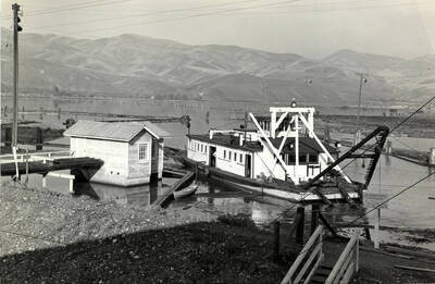 The description written on the back of the photograph reads '"Dredge Clara" working on mill pond of Clearwater plant PFI. 2009-CL.'