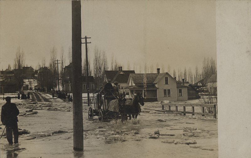 Postcard is of a flood scene in Wallace, Idaho.