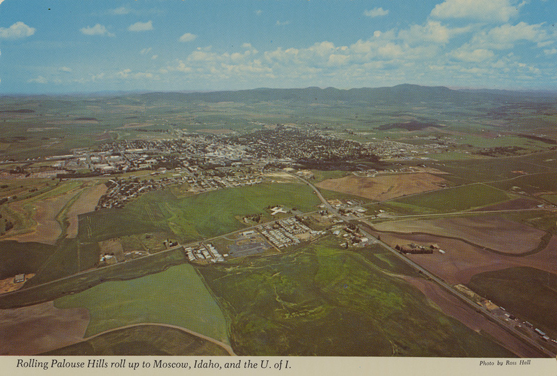 Postcard is an aerial photograph of Moscow, Idaho and the University of Idaho.