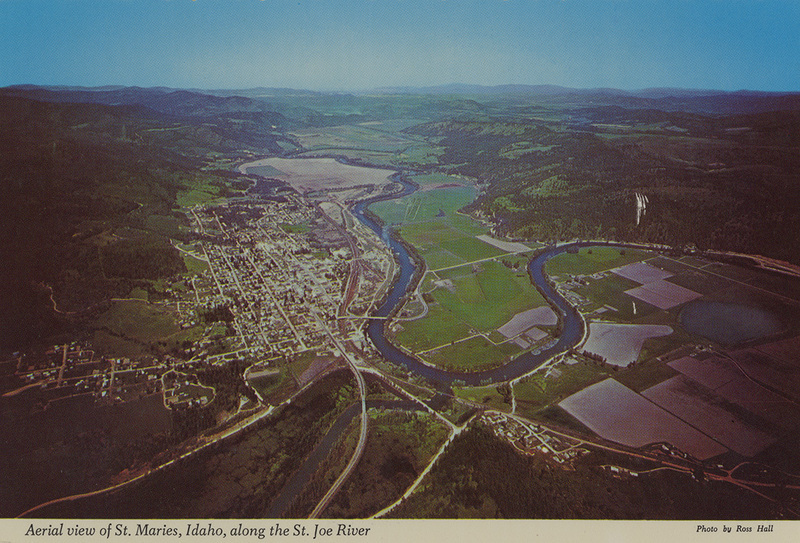Postcard is an aerial photograph of St. Maries, Idaho.