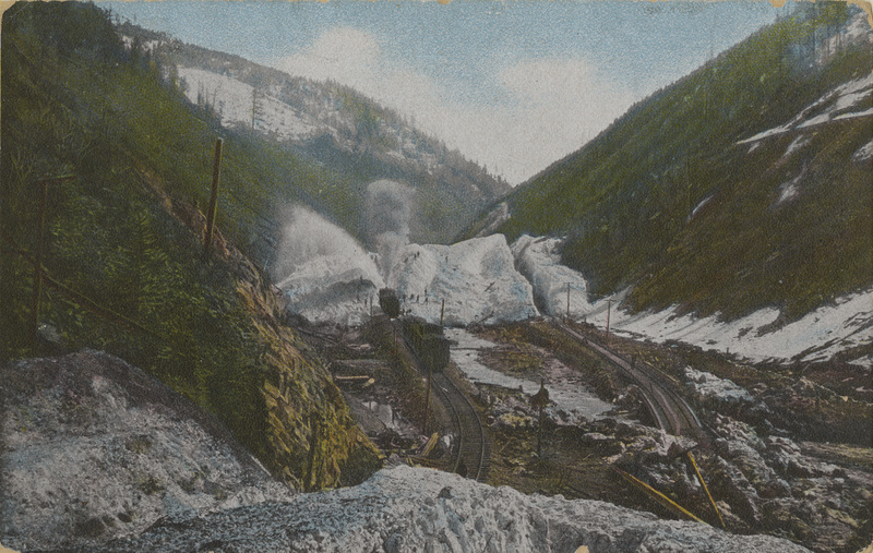 Postcard of railroad tracks after a snow slide on Canyon Creek near Mace, Idaho.