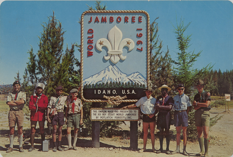 Postcard of Boy Scouts posing next to a sign at Farragut Park, Idaho. | Some 12,000 Boy Scouts from 108 nations participated in the Jamboree on Lake Pend Oreille, August 1-9, 1967. These boys are from the following nations, L to R: England, Philippines, Indonesia, France, Canada, Jamaica, Sweden, U.S.A.