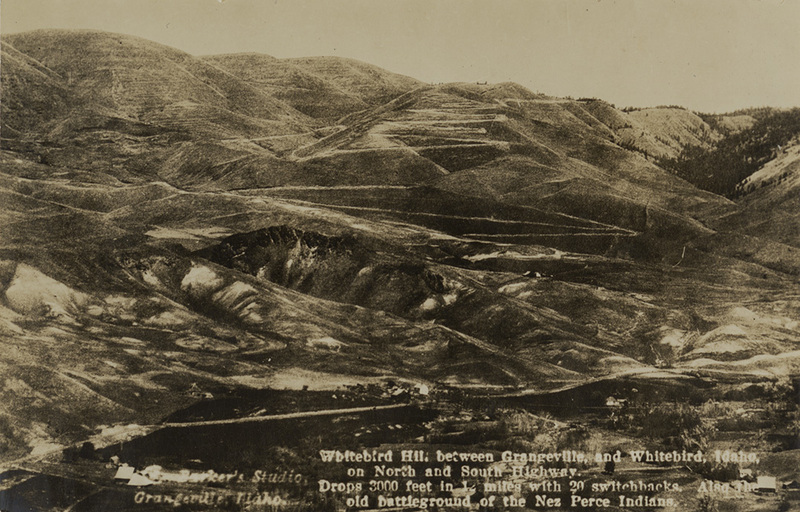Postcard is of a winding road near White bird, Idaho. | White bird Hill between Grangeville and White bird, Idaho on North and South Highway. Drops 3000 feet in 12 miles with 20 switchbacks. Also the old battleground of the Nez Perce Indians.