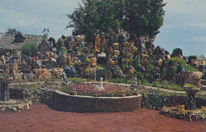 Postcard of the Petersen Rock Garden near Redmond, Oregon. | The Petersen Rock Gardens were started some years ago as a hobby by Mr. Petersen on his farm in the sage-brush land of Deschutes county in Central Oregon. The gardens have become so famous that more than 200,000 visitors annually sign the register.