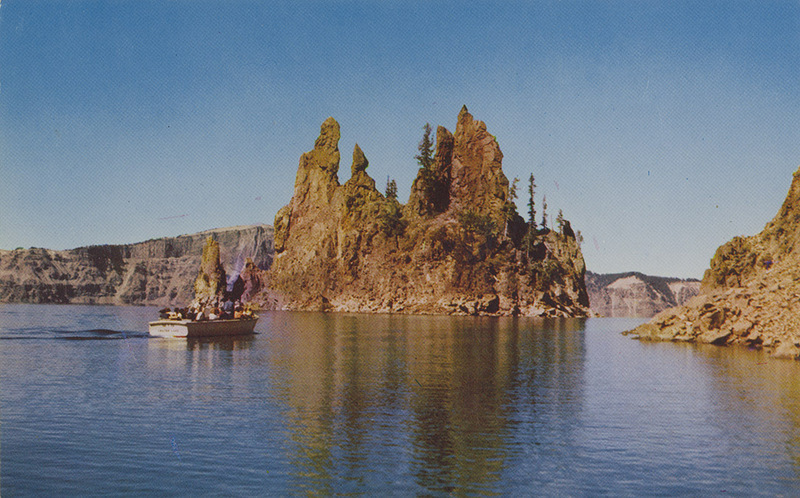 Postcard of the Phantom Ship in Crater Lake National Park. | Towering more than 165 feet above Crater Lake's blue, the Phantom Ship, formed by the volcano whose eruptions created the lake, serenely withstands the centuries.