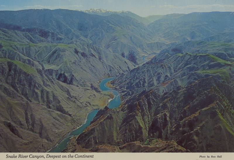 Postcard of the Snake River Canyon. | Snake River Canyon on Idaho line, as viewed up this rugged and tortuous river. This is part of Hells Canyon, 5500 ft. deep - deepest on the continent. The Seven Devils, 9410 ft., are in the background, set aside as a Forest Service Scenic area.