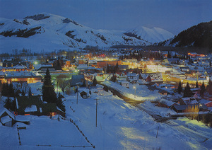 Postcard of Ketchum, Idaho at night. | Ketchum, Idaho, winter evening. Dollar Mountain ski area at left.