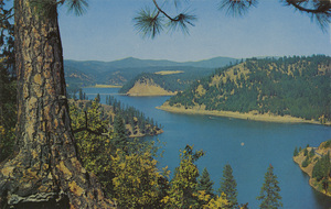 Postcard of Beauty Bay at Lake Coeur d'Alene, Idaho. | Beauty Bay, Lake Coeur d'Alene, one of America's most beautiful lakes, situated in North Idaho, 100 miles from the Canadian border. Hiway 10 and Blue Creek Bay Bridge may be seen at Left Center.