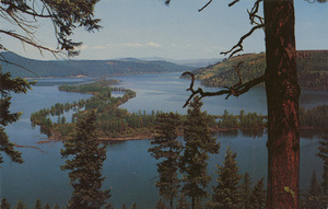 Postcard of Chatcolet Lake near St. Maries, Idaho. | Chatcolet Lake, near St. Maries, North Idaho. One of nature's curiosities, (once featured by Ripley) is the shadowy St. Joe River meandering through lovely Lake Chatcolet. Location of a state park, the vicinity finds much summer use.