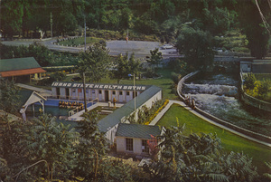 Postcard of Lava Hot Springs in Lava Hot Springs, Idaho. | 70 acres of landscaping, free picnic grounds, phenomenal natural sunken gardens, and golf course are the most enjoyable, restful and healthful, paralleling the banks of the tumbling waters of the clear cold Portneut River filled with hungry trout jumping continuously for food tossed in by children and grownups, an unusual, interesting and amusing pastime. Located on Hi-way 30N and the main line of U.P.R.R. Write Lava Hot Springs Foundation for further information.