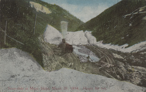 Postcard of railroad tracks after a snow slide on Canyon Creek near Mace, Idaho.