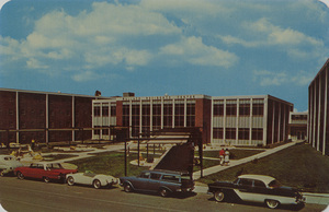 Postcard of the Wallace Residence Center on the University of Idaho campus in Moscow, Idaho. | Exemplifying the most modern dormitory facilities, the Wallace Residence Center has a central cafeteria which is winged by halls providing rooms in suites. The suites have their own bathroom as well as study and sleeping quarters. In each suite, four students share campus living experiences.