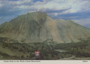 Postcard of a woman hiking near Castle Peak in the White Cloud Mountains near Stanley, Idaho. | Castle Peak, part of the White Cloud Mountains that are the eastern range of the Rocky Mountains in the Stanley Basin of Idaho.