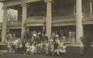 Postcard of children and adults posing in front of the Children's Home in Lewiston, Idaho.